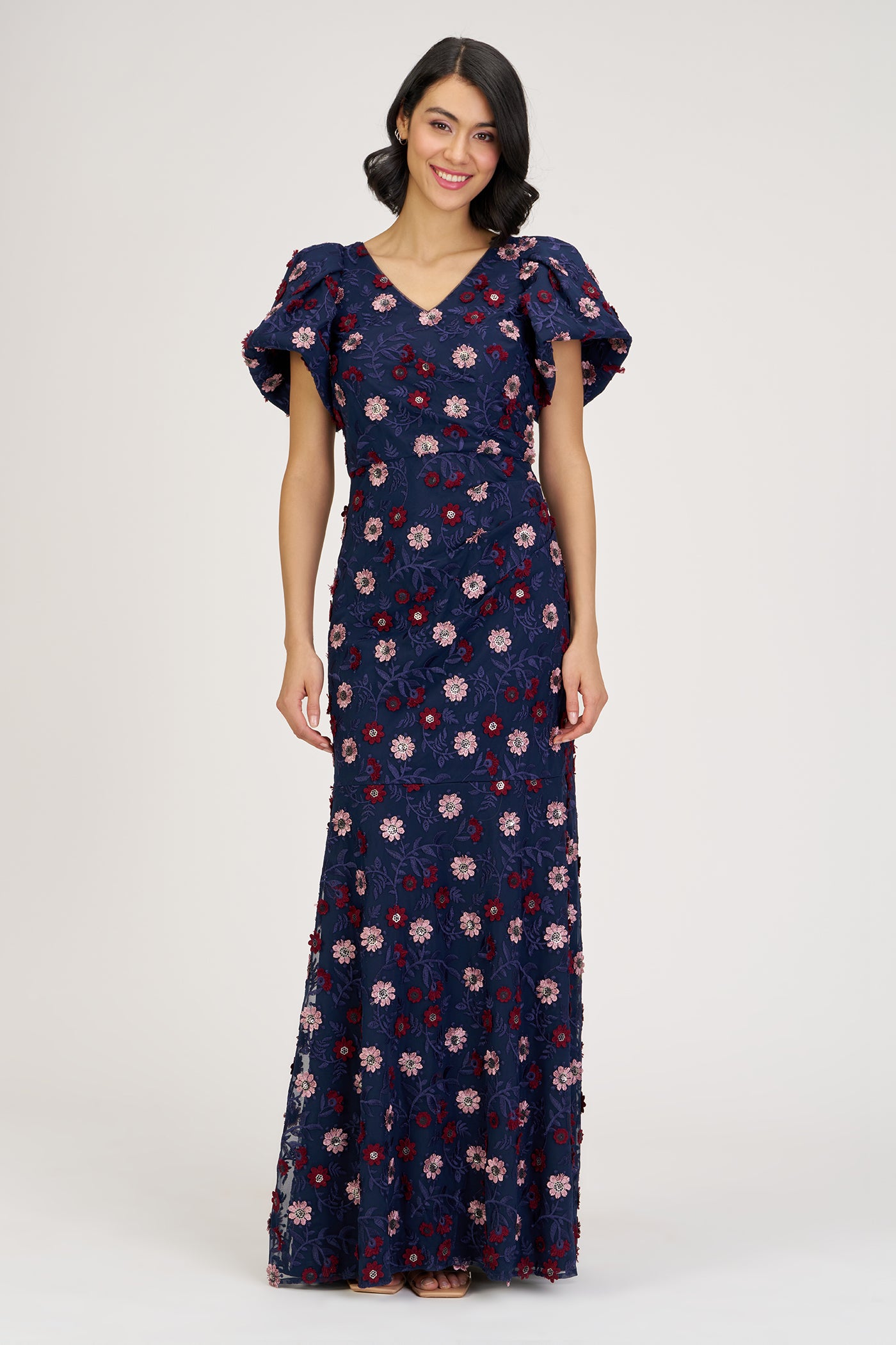 Woman wearing a floral dress on a white background