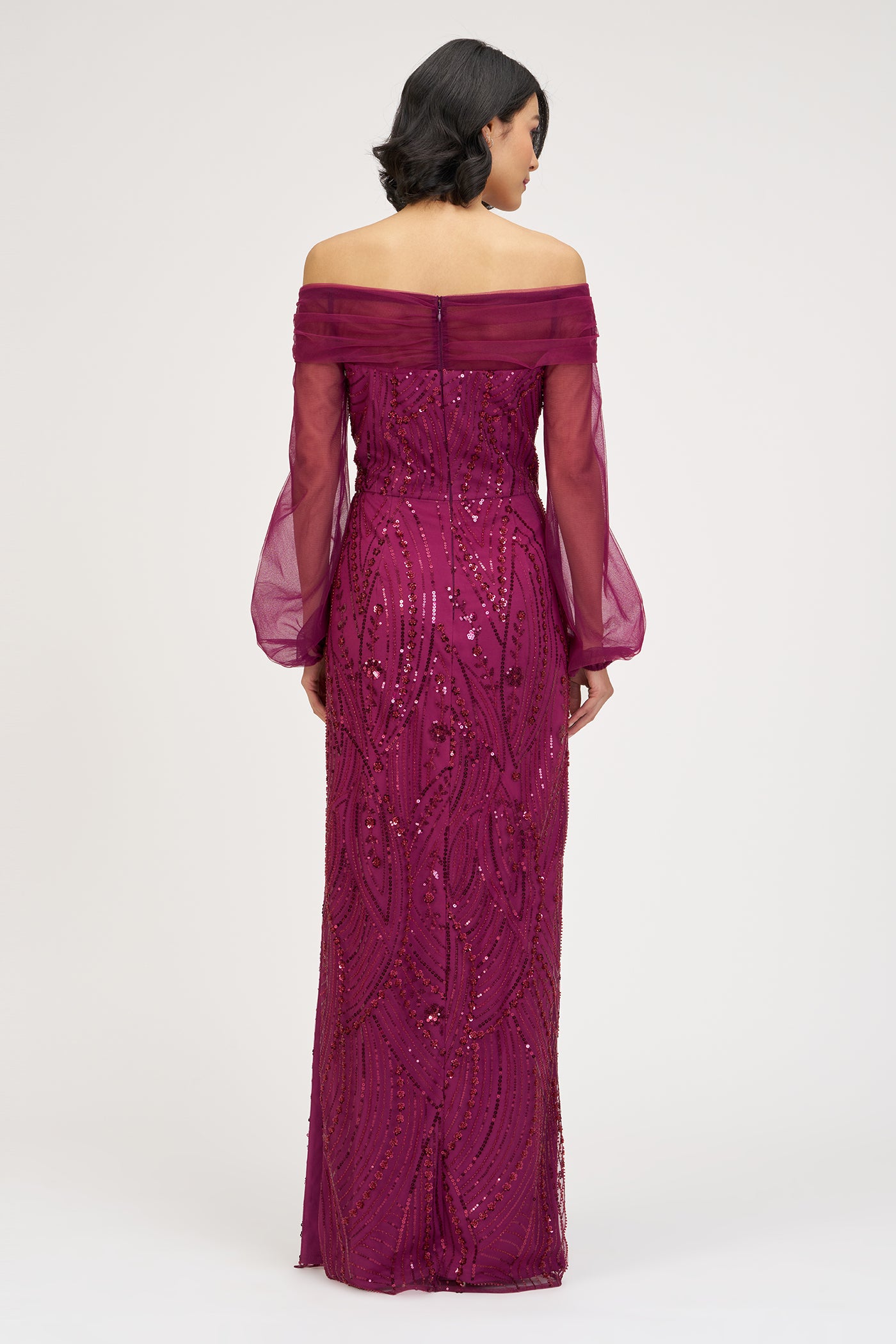 Purple off-shoulder gown with long sleeves on a white background