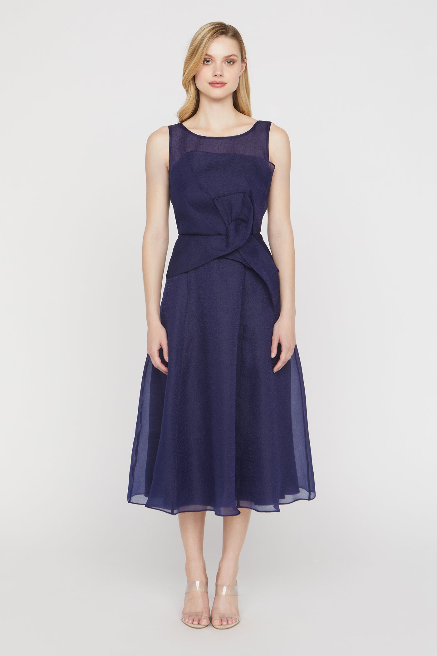 Woman wearing a navy blue dress on a white background