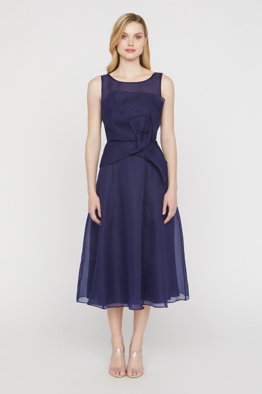 Woman wearing a navy blue dress on a white background