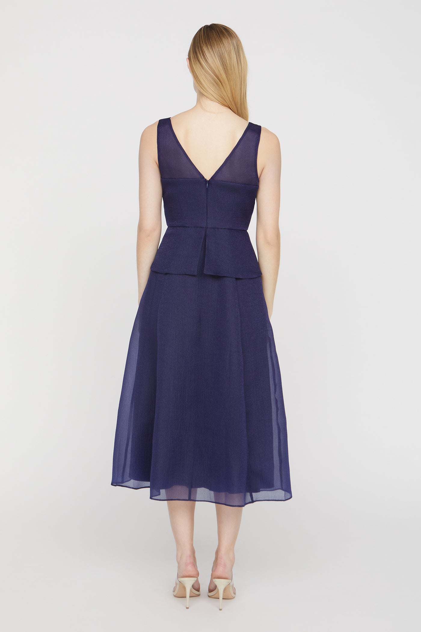 Woman wearing a navy blue dress on a white background