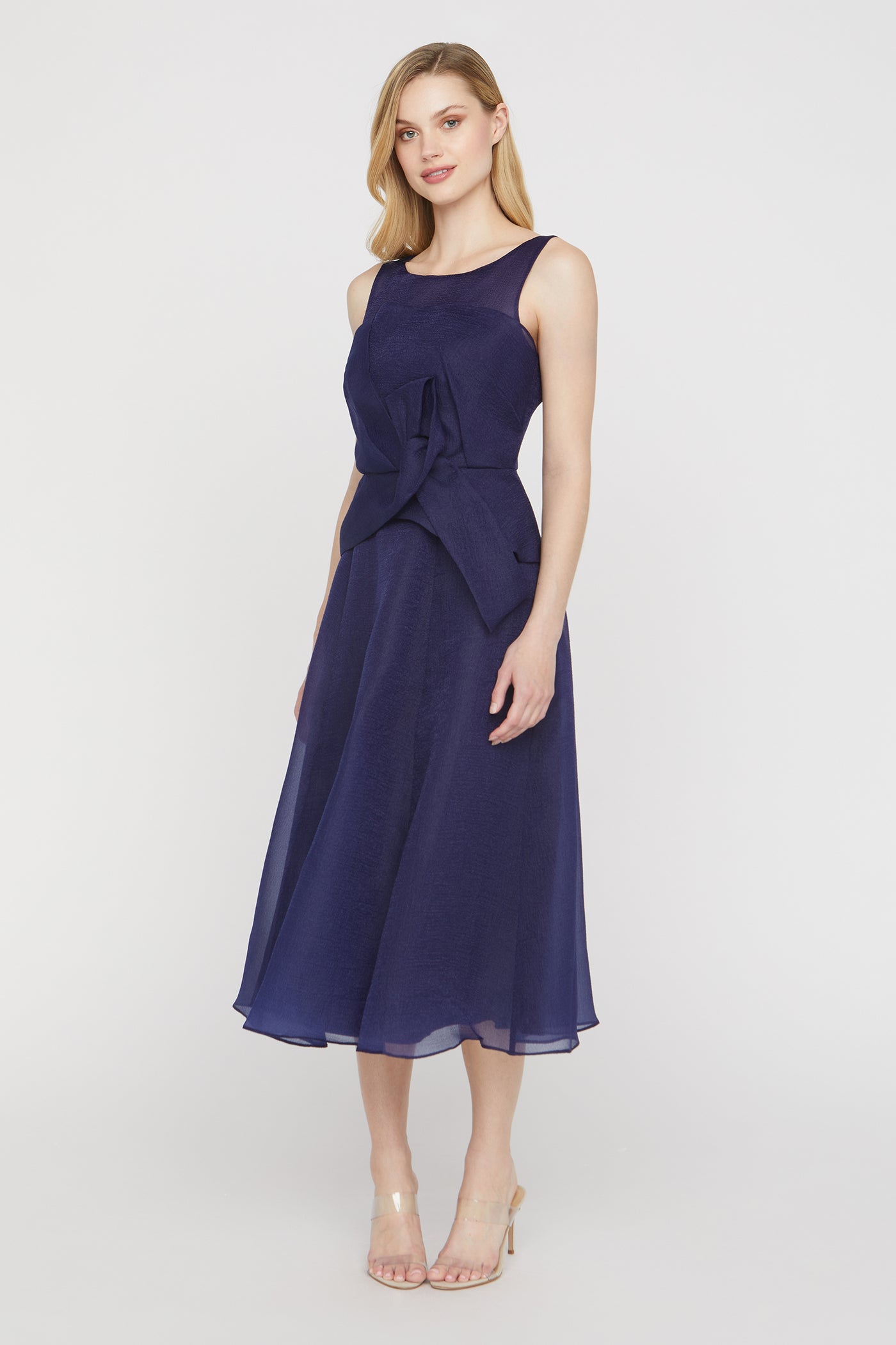 Woman wearing a navy blue dress on a white background