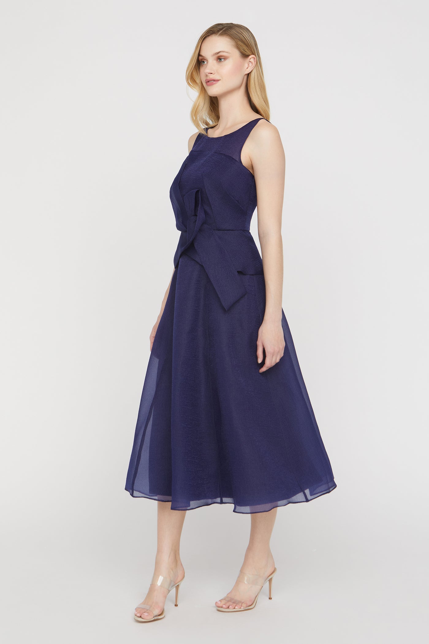 Woman wearing a navy blue dress on a white background