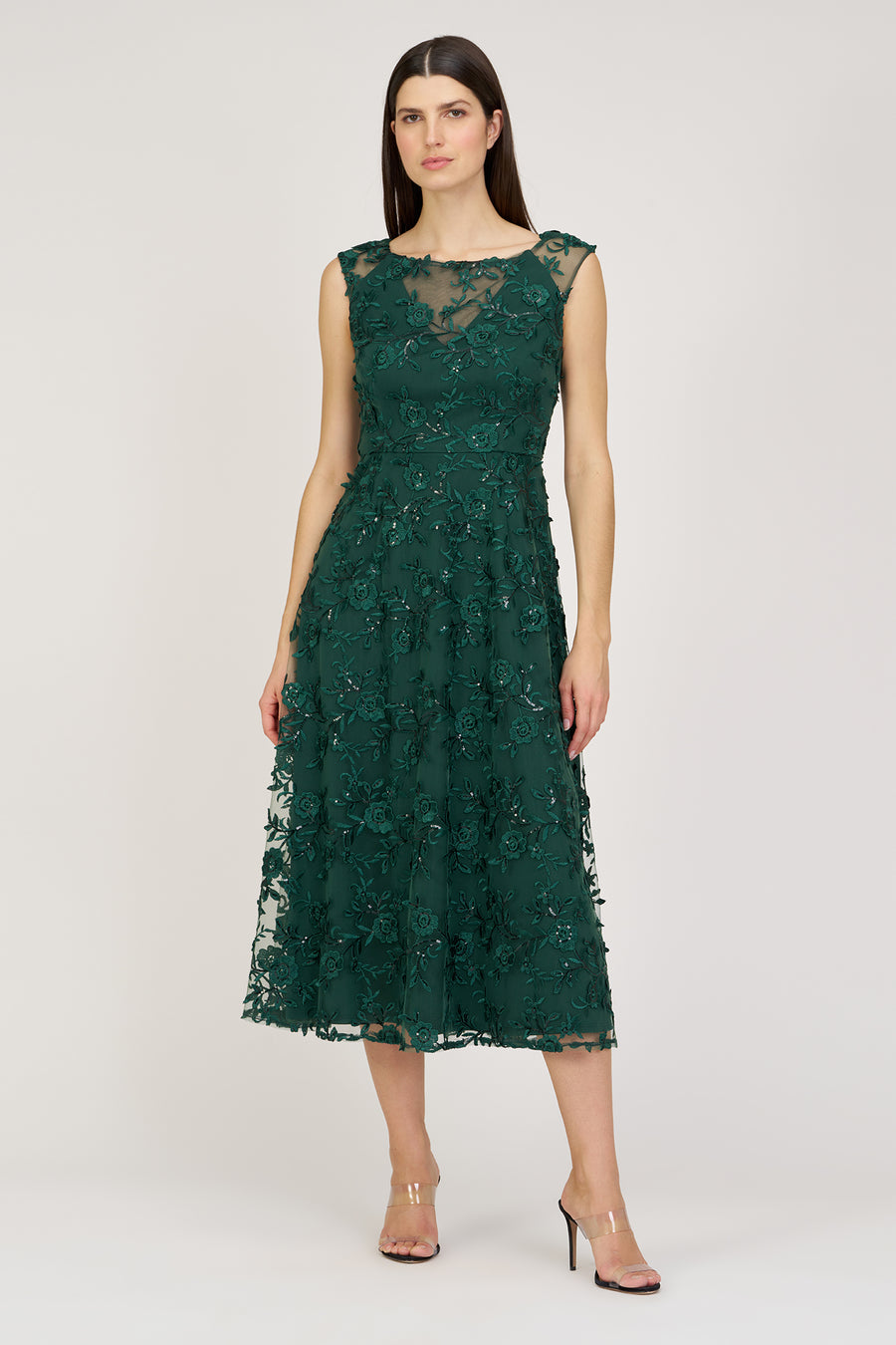 Woman wearing a green lace dress on a white background