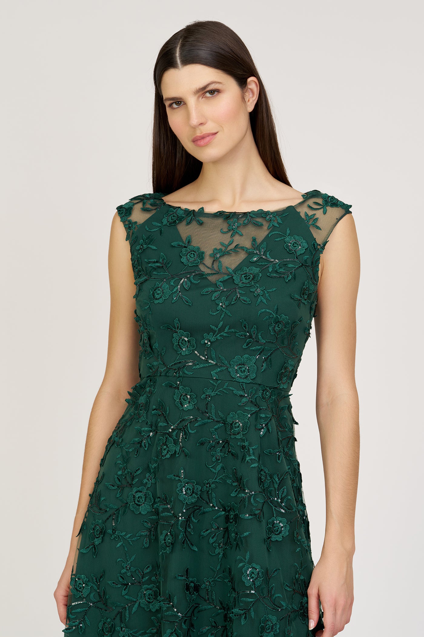 Woman wearing a green lace dress on a white background