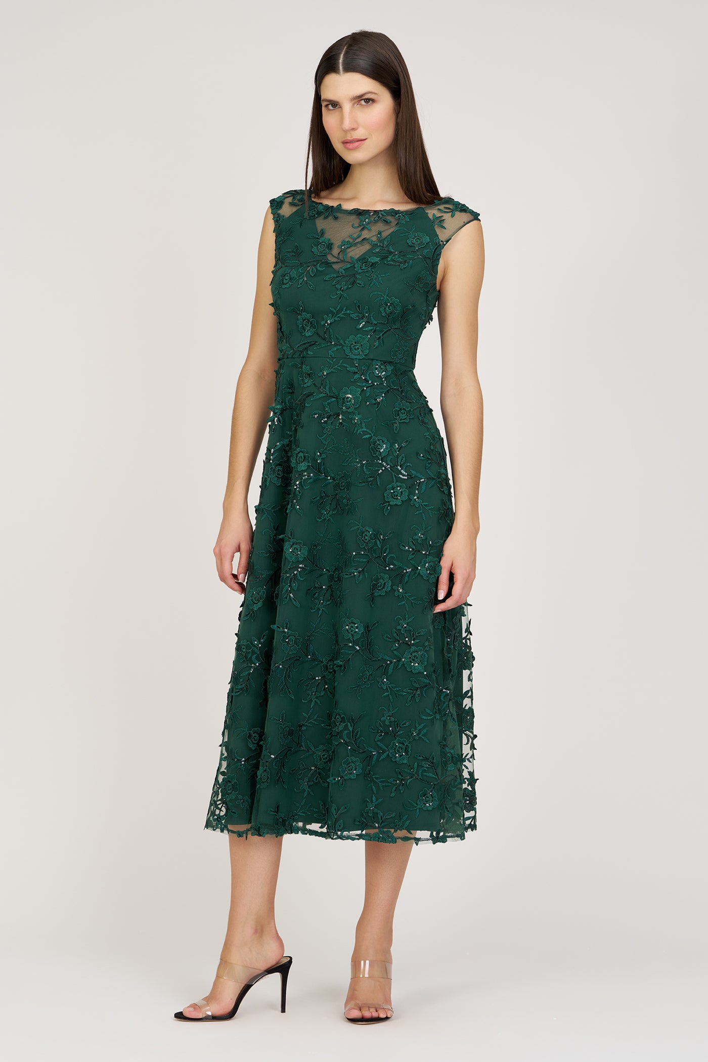 Woman wearing a green lace dress on a white background