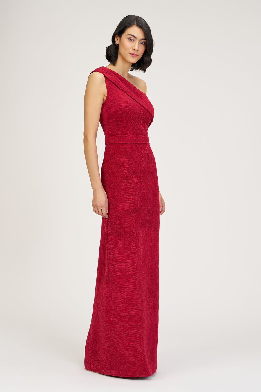 Woman wearing a red one-shoulder dress on a white background