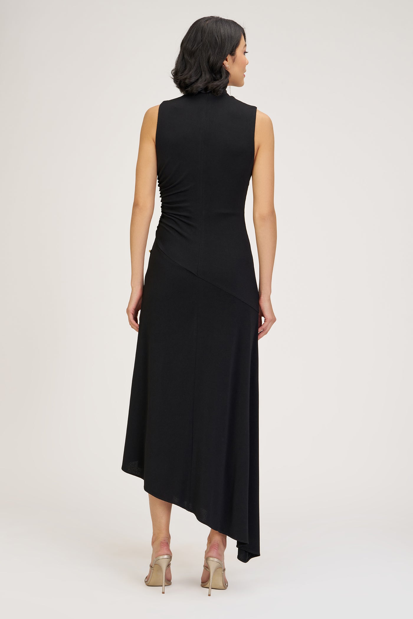 Woman wearing a black sleeveless dress on a white background