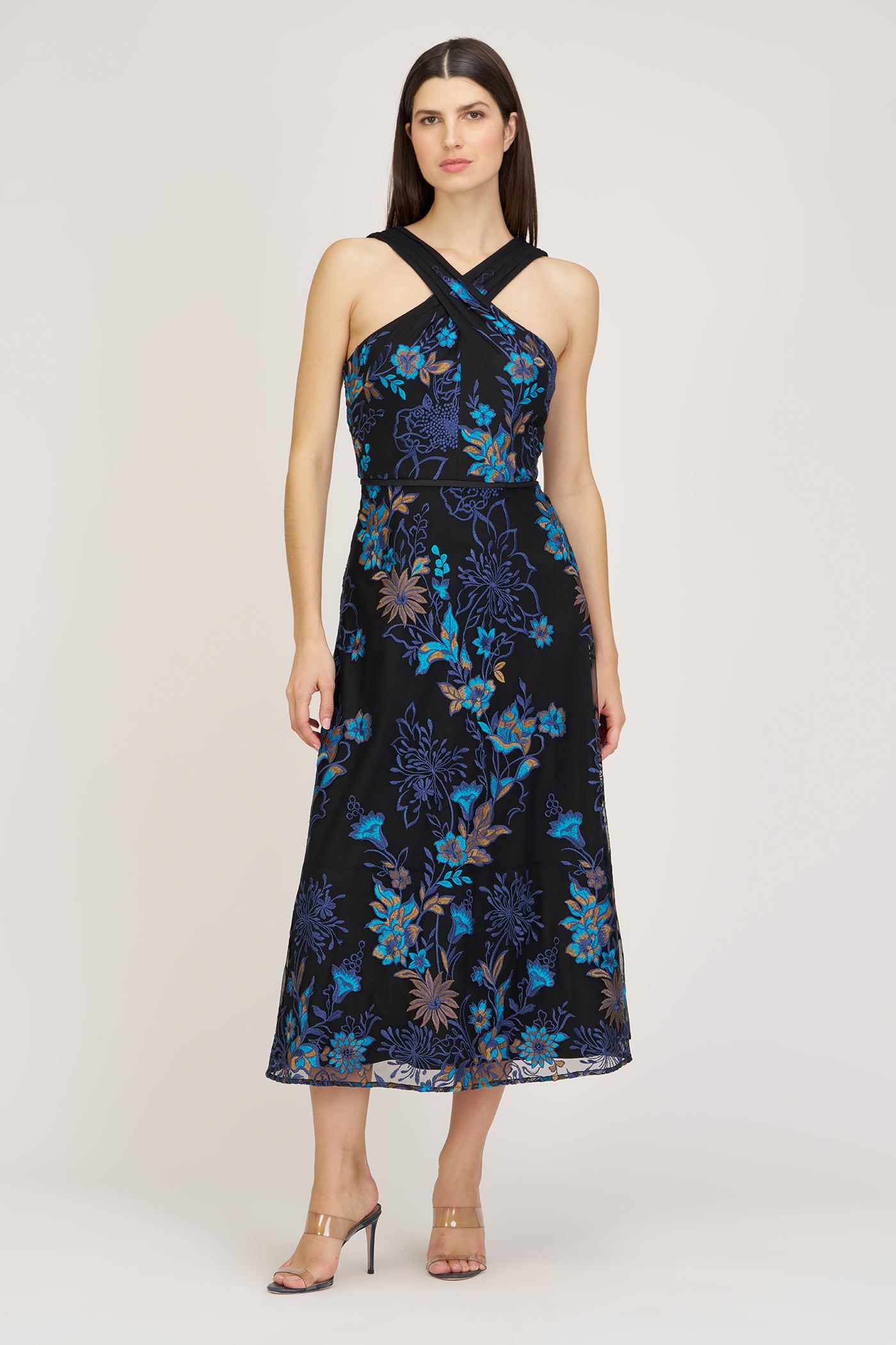 Woman wearing a black floral dress on a white background