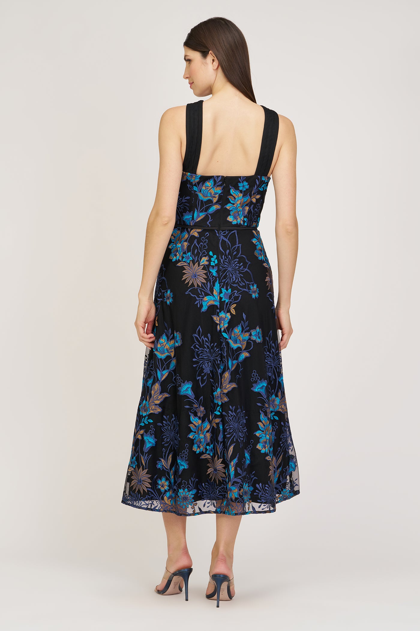 Woman wearing a black floral dress on a white background