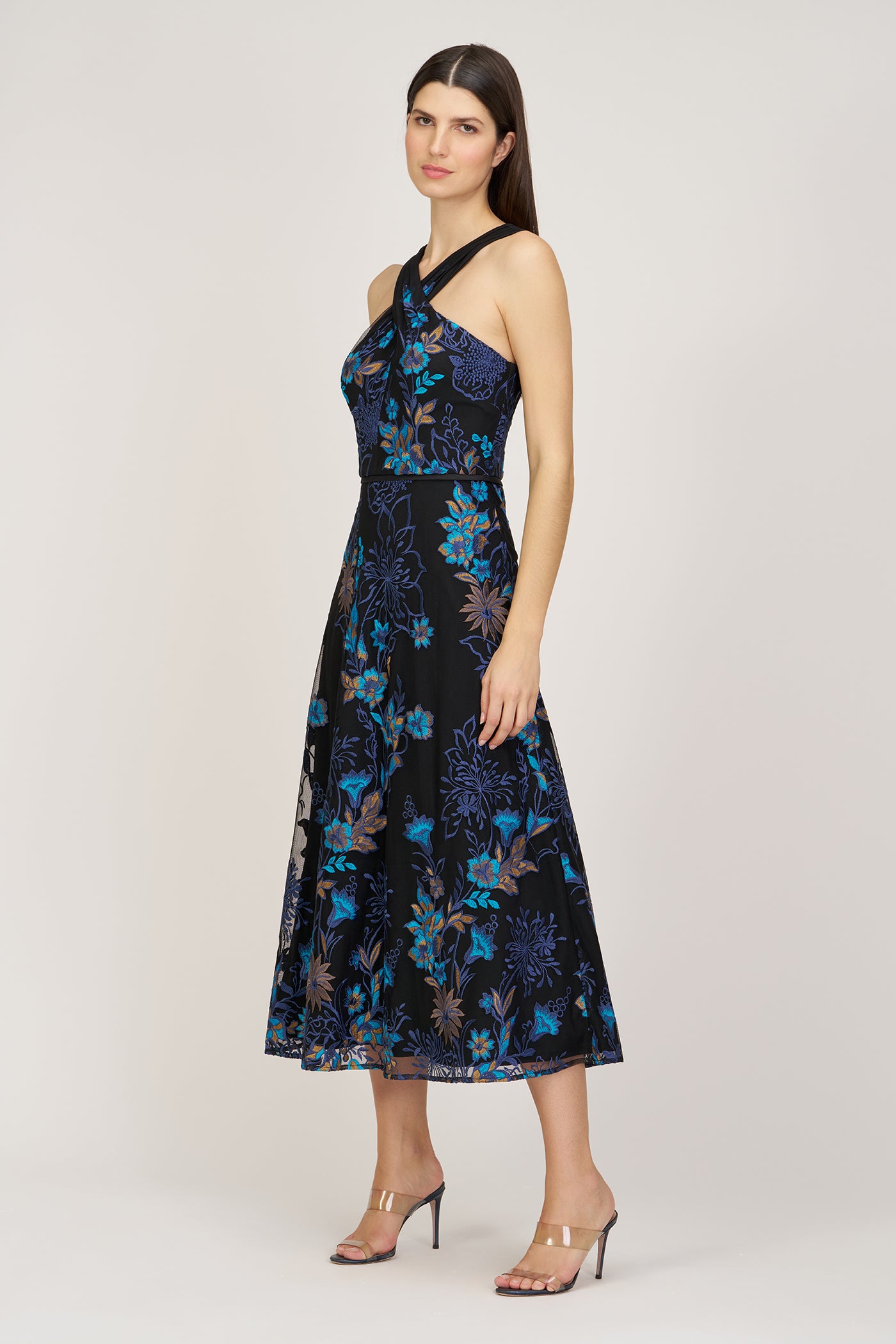 Woman wearing a black floral dress on a white background