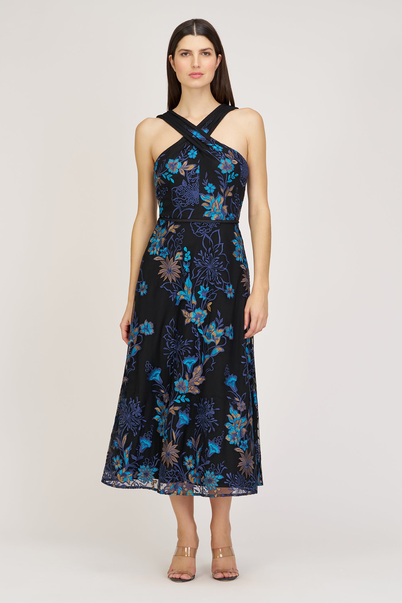 Woman wearing a black floral dress on a white background