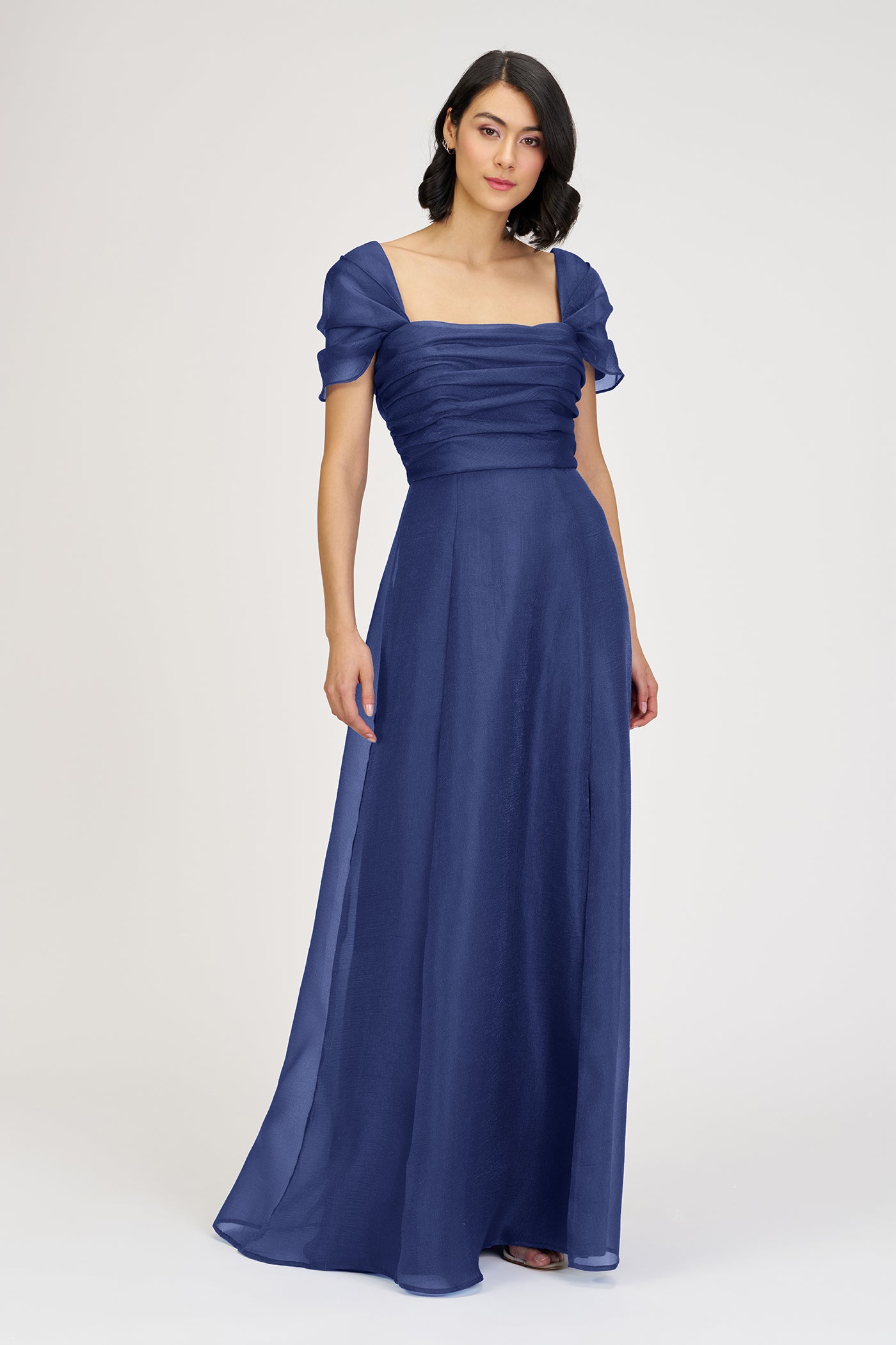 Woman wearing a blue evening gown on a white background